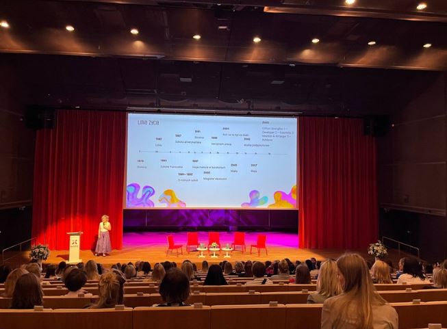 Paulina on stage in a full auditorium
